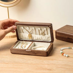 a person holding a necklace in a wooden box